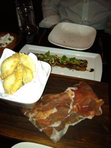 Cassoncini (swiss chard and crescenza cheese filled fried dough, prosciutto di parma) shown in front; and Pancetta (pork belly, figs, balsamic, pistachios) shown behind